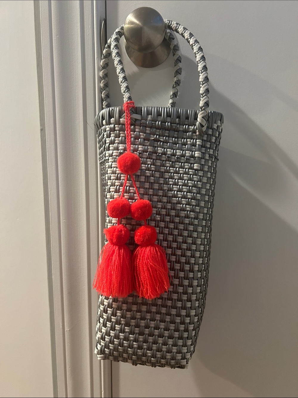 Woven Gray Tote Bag with Red Tassel Accent